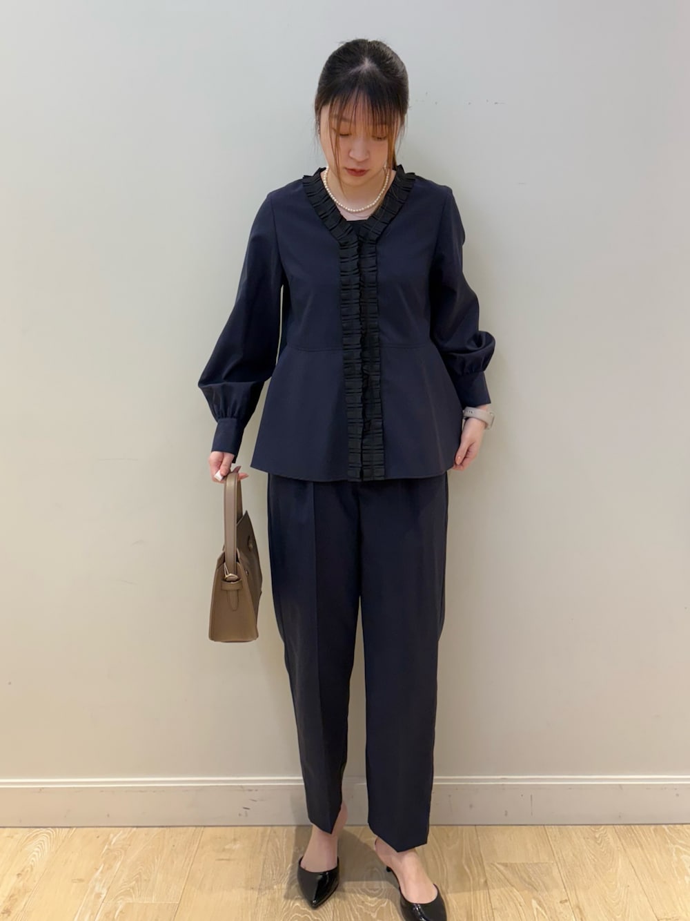 ベージュ系のショルダーバッグ、ブラック系のタンクトップ、ブルー系のシャツ/ブラウスを着用したレディースの冬コーディネートの1枚目の写真