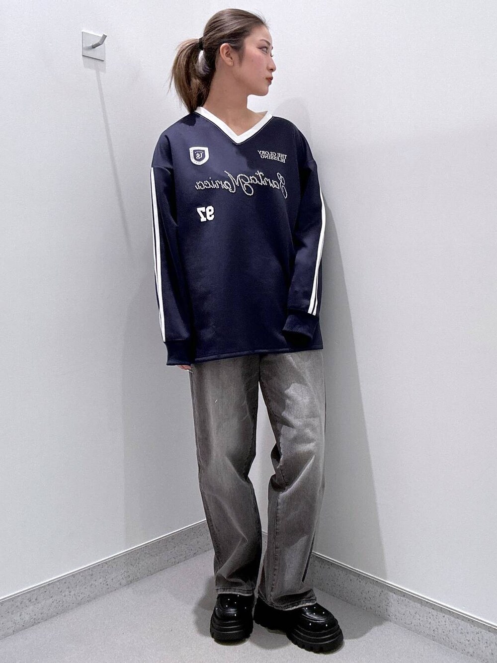 ブラック系のローファー、グレー系のデニムパンツ、ブルー系のTシャツ/カットソーを着用したレディースの冬コーディネートの1枚目の写真