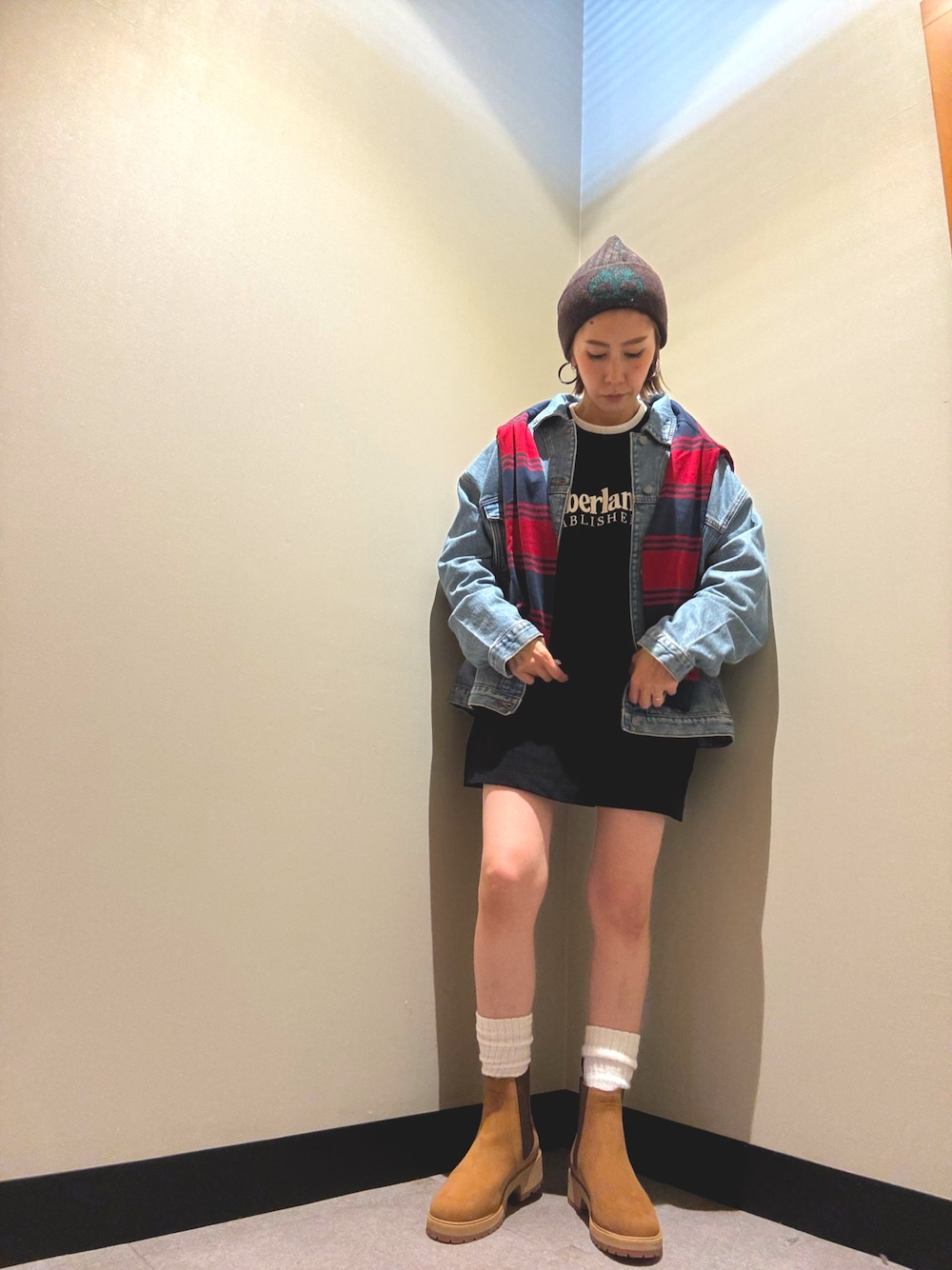 レッド系のポロシャツ、ブラック系のTシャツ/カットソー、ブルー系のデニムジャケットを着用したレディースの秋コーディネートの1枚目の写真