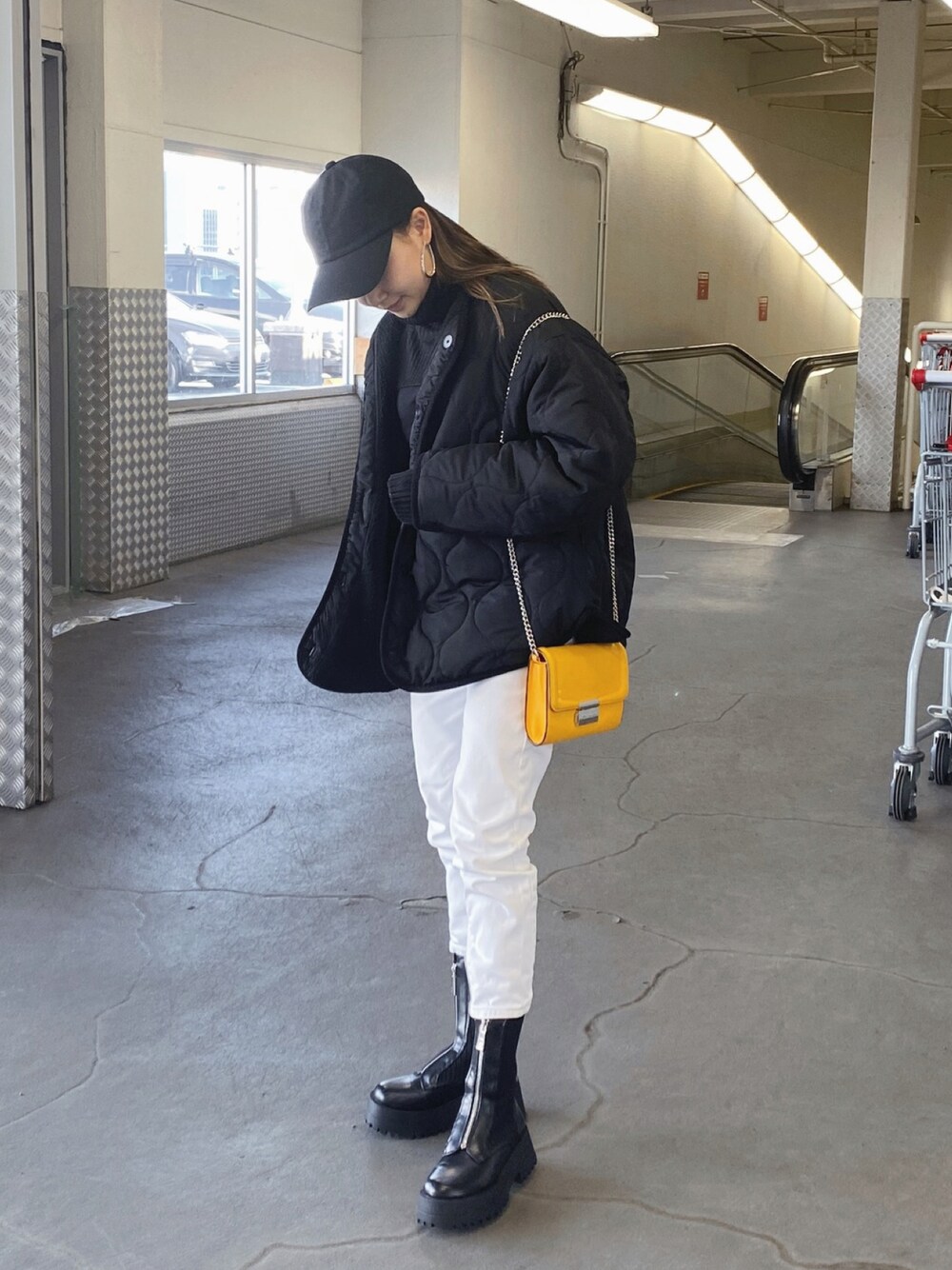 ブラック系のノーカラージャケット、イエロー系のショルダーバッグ、ホワイト系のデニムパンツを着用したレディースの秋コーディネートの1枚目の写真