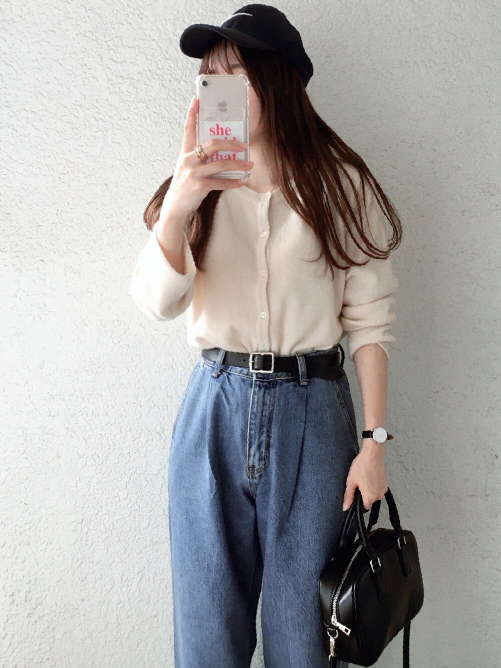 ホワイト系のカーディガン/ボレロ、ブルー系のデニムパンツ、ブラック系のショルダーバッグを着用したレディースの秋コーディネートの1枚目の写真