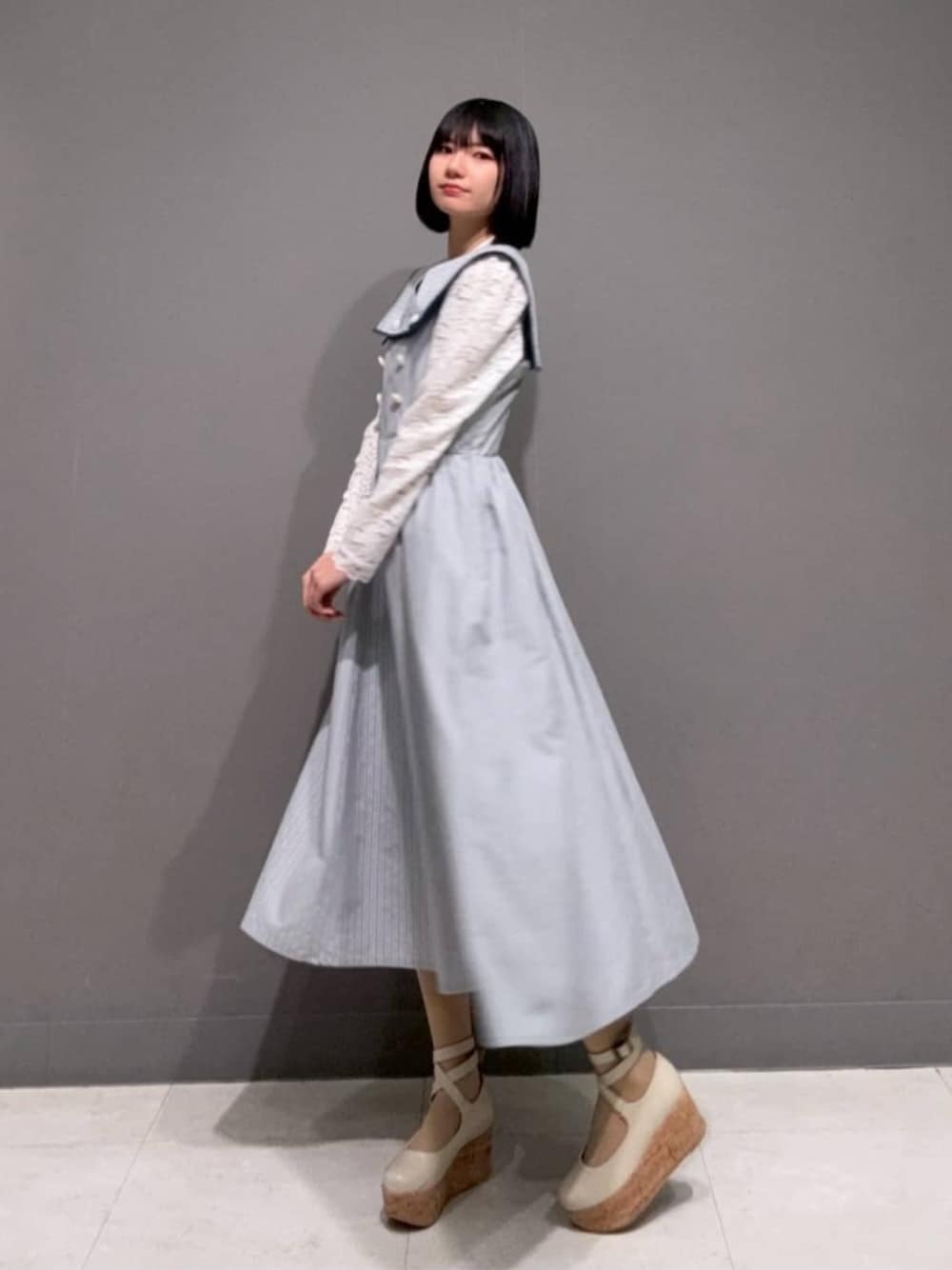 ホワイト系のパンプス、ホワイト系のTシャツ/カットソー、ブルー系のワンピースを着用したレディースの春コーディネートの1枚目の写真