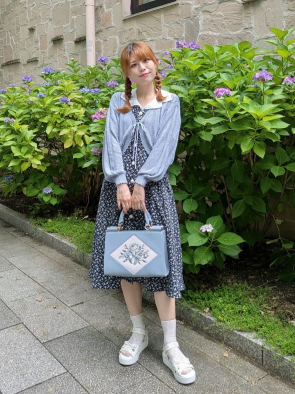 ブラック系のワンピース、ホワイト系のサンダル、ブルー系のトートバッグを着用したレディースの夏コーディネートの1枚目の写真