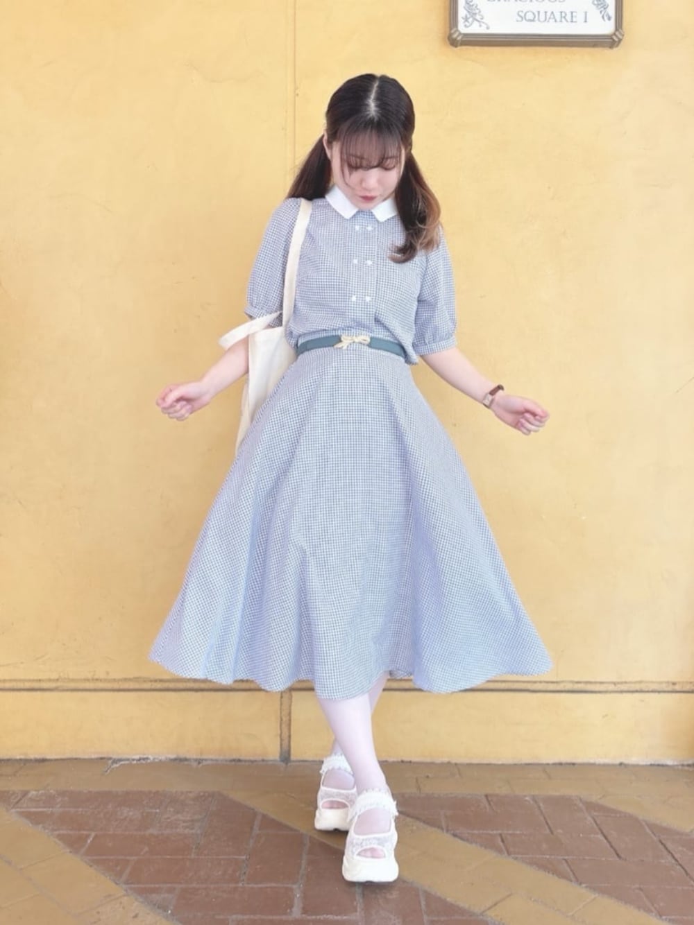 ホワイト系のスニーカー、ホワイト系のスカート、ホワイト系のシャツ/ブラウスを着用したレディースの春コーディネートの1枚目の写真