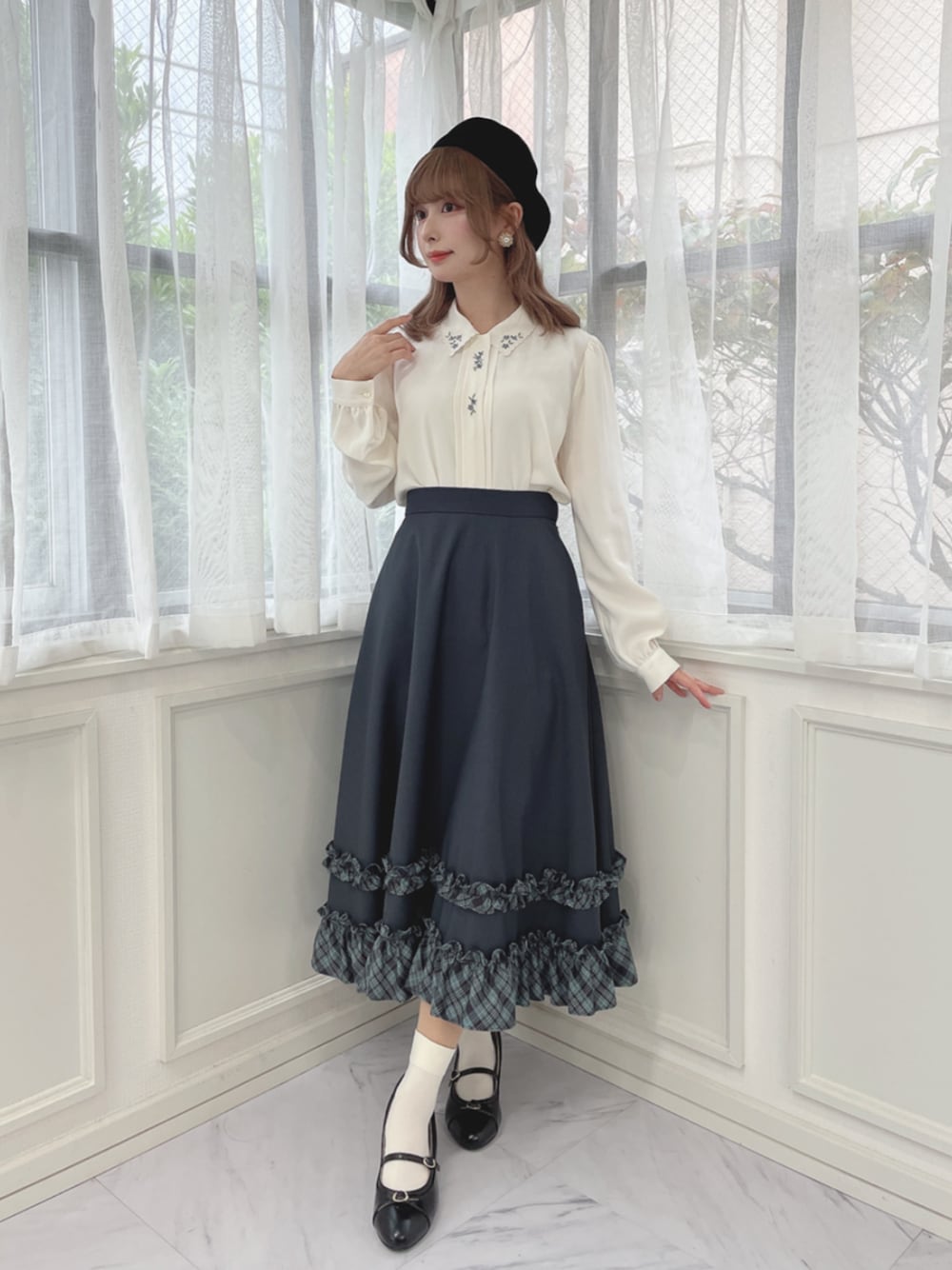 ブラック系のパンプス、ブルー系のスカート、ホワイト系のシャツ/ブラウスを着用したレディースの秋コーディネートの1枚目の写真