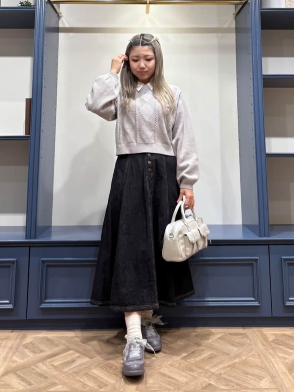 シルバー系のハンドバッグ、グレー系のスニーカー、ホワイト系のシャツ/ブラウスを着用したレディースの冬コーディネートの1枚目の写真