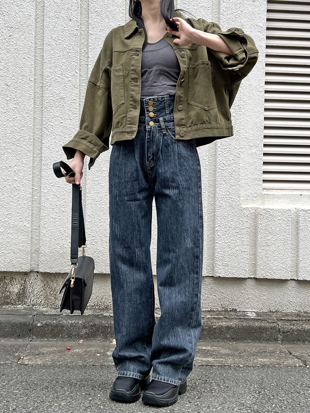 グリーン系のブルゾン、グレー系のキャミソール、ブルー系のデニムパンツを着用したレディースの春コーディネートの1枚目の写真