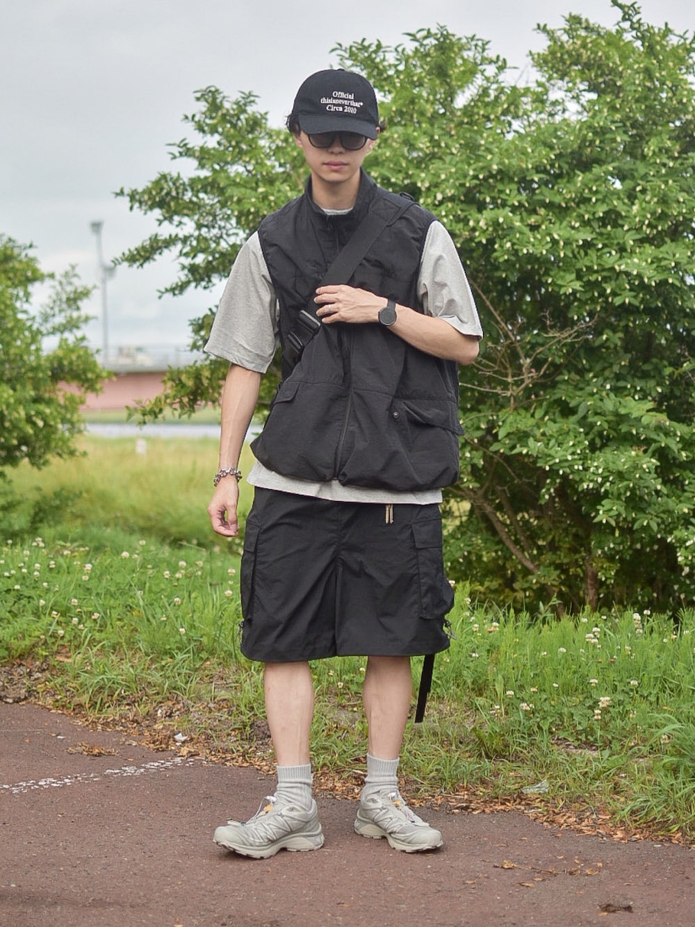 「ベスト、スウェット、Tシャツ、レイヤードスタイル、夏コーデ、キャップ、thisisneverthat、SALOMON、ハーフパンツ、カーゴパンツ、シンプルコーデ、モノトーン、WYM、サングラス、大人カジュアル」｜「INTERPLAYの【INTERPLAY x たいが】カーゴ ドローストリングス ショートパンツ（カーゴパンツ、ブラック系）」を使った、たいがさん（メンズ・172cm）の夏コーディネートの1枚目の写真