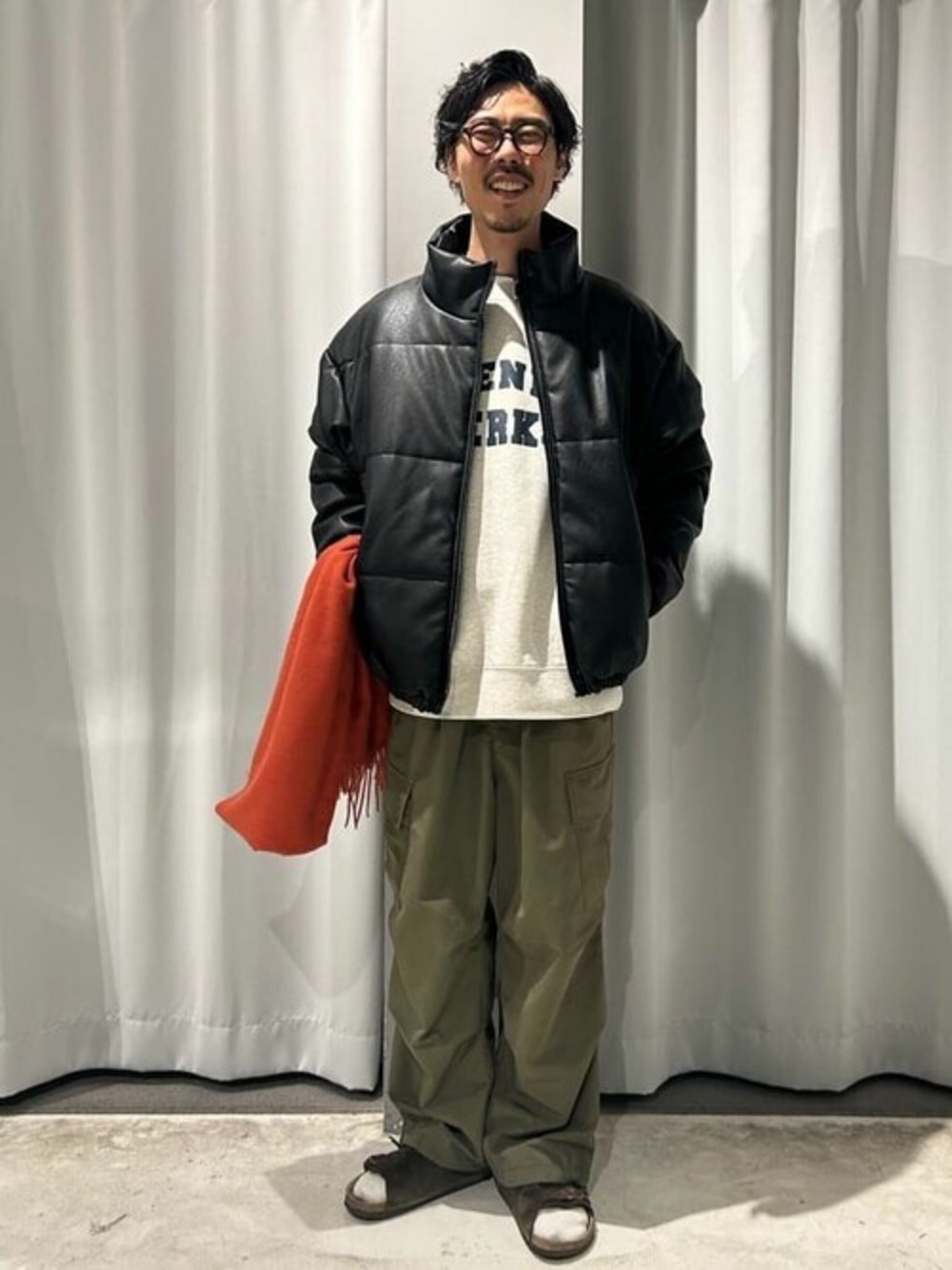 ブラック系のブルゾン、グリーン系のカーゴパンツ、ベージュ系のTシャツ/カットソーを着用したメンズの冬コーディネートの1枚目の写真