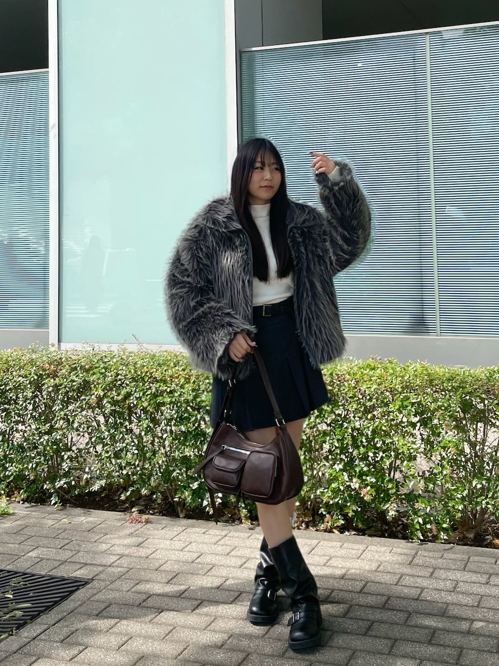 グレー系のブルゾン、ホワイト系のニット/セーター、ブラウン系のショルダーバッグを着用したレディースの秋コーディネートの1枚目の写真