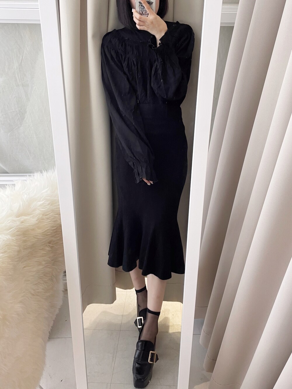 ブラック系のシャツ/ブラウス、ベージュ系のスカート、ブラック系のローファーを着用したレディースの秋コーディネートの1枚目の写真