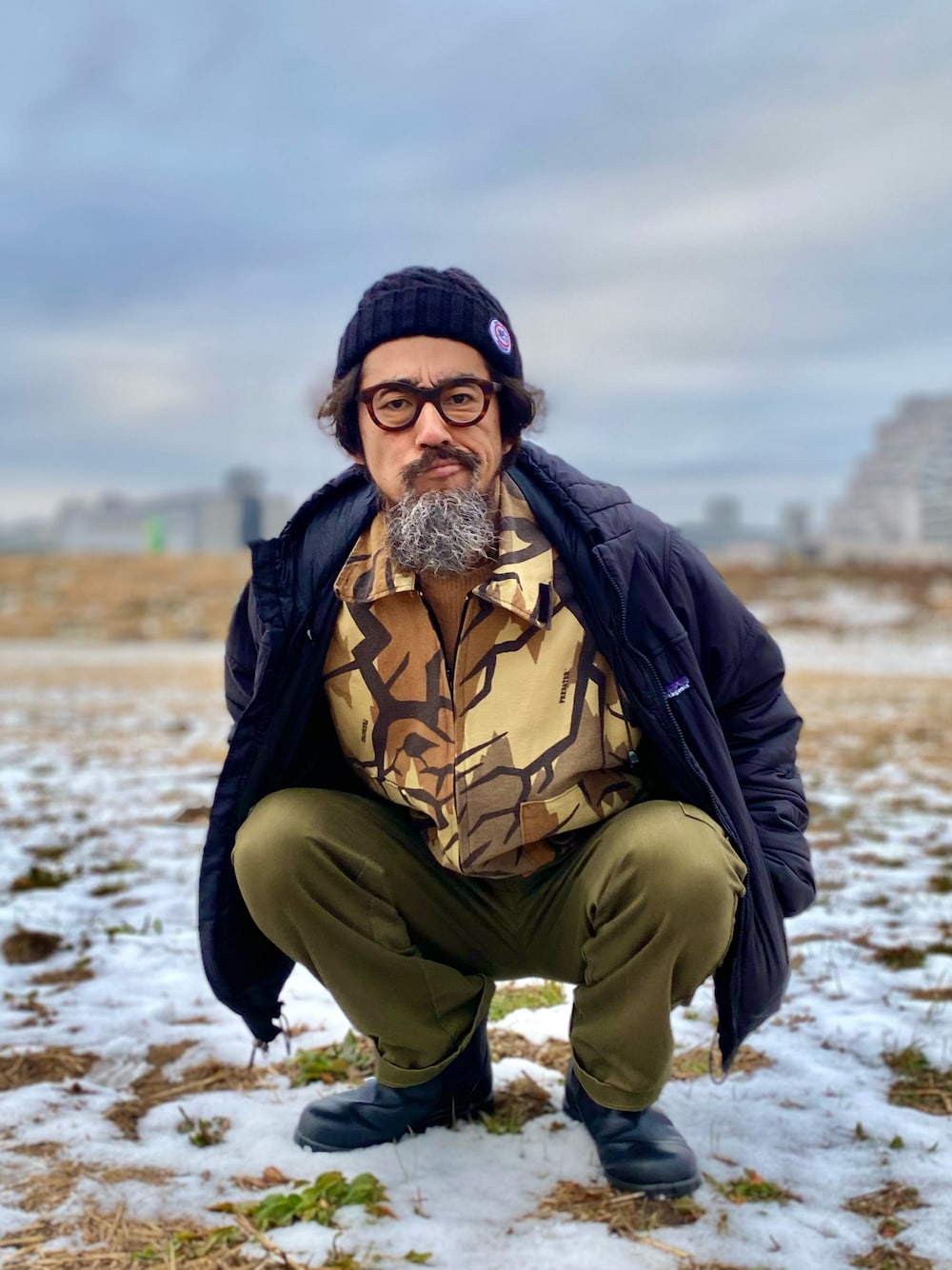 「patagonia、ダウンジャケット、カモフラ、迷彩、タートルネック、カーゴパンツ、ブーツ、ニット帽、アメカジ、古着MIX、アウトドアスタイル、休日スタイル、レイヤードスタイル、メガネ男子、ヴィンテージ」｜「SAINT JAMESのアイテム（ニットキャップ/ビーニー、ブラック系）」を使った、ヤギハシカズヒロさん（メンズ・181cm）の冬コーディネートの1枚目の写真