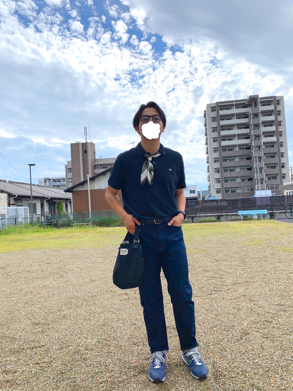 ブラック系のハンドバッグ、ブルー系のデニムパンツ、ブルー系のスニーカーを着用したメンズの秋コーディネートの1枚目の写真