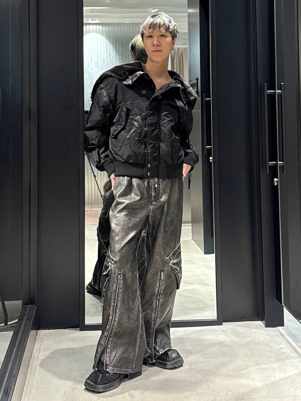 ブラック系のブルゾン、グレー系のカーゴパンツを着用したメンズの冬コーディネートの1枚目の写真