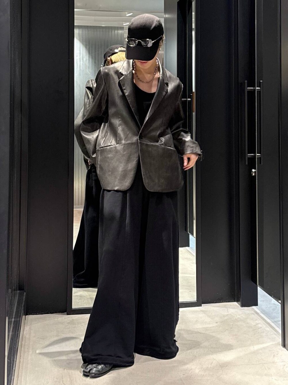 ブラック系のTシャツ/カットソー、ブラック系のスウェットパンツ、ブラック系のキャップを着用したメンズの冬コーディネートの1枚目の写真