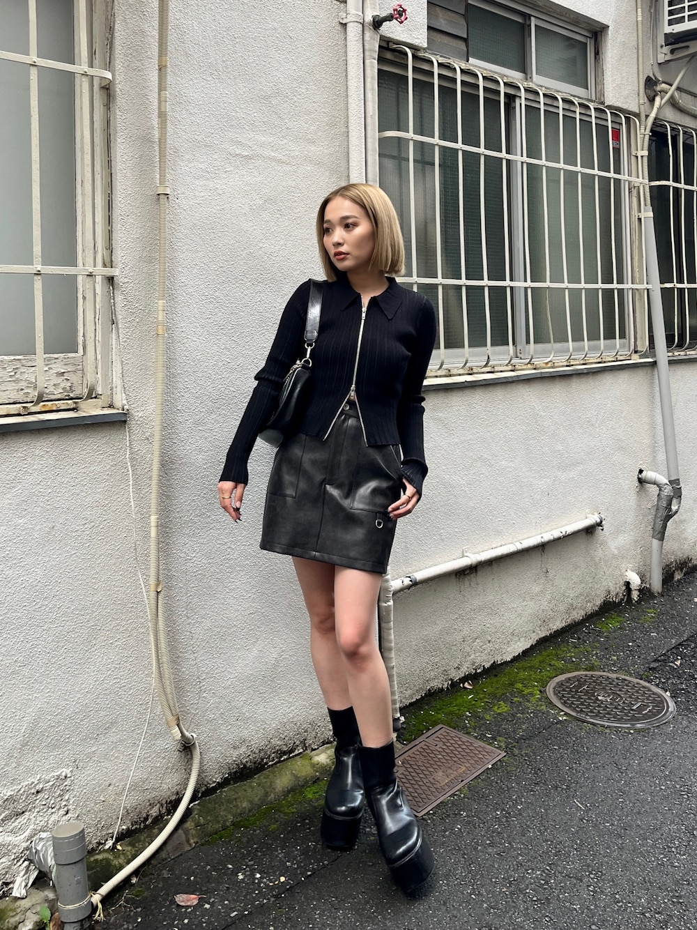 ブラック系のニット/セーター、ブラック系のブーツ、ブラック系のスカートを着用したレディースの冬コーディネートの1枚目の写真