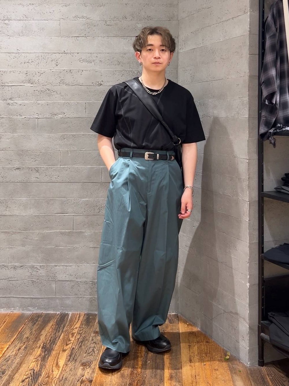 ブラック系のローファー、ブラック系のショルダーバッグ、グリーン系のチノパンツを着用したメンズの夏コーディネートの1枚目の写真