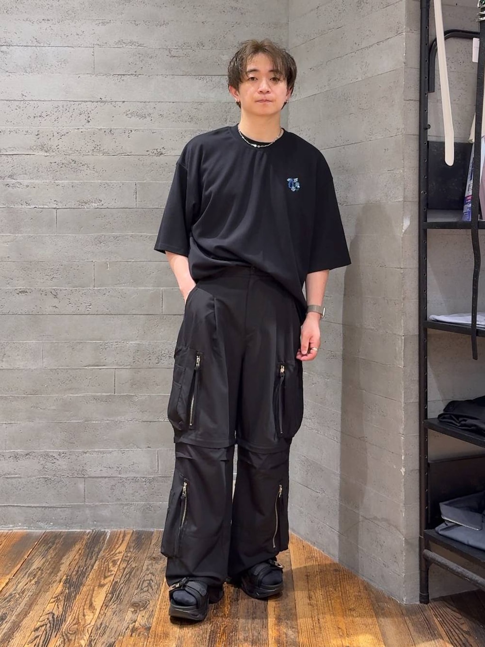 ブラック系のTシャツ/カットソー、ブラック系のサンダル、ブラック系のカーゴパンツを着用したメンズの夏コーディネートの1枚目の写真