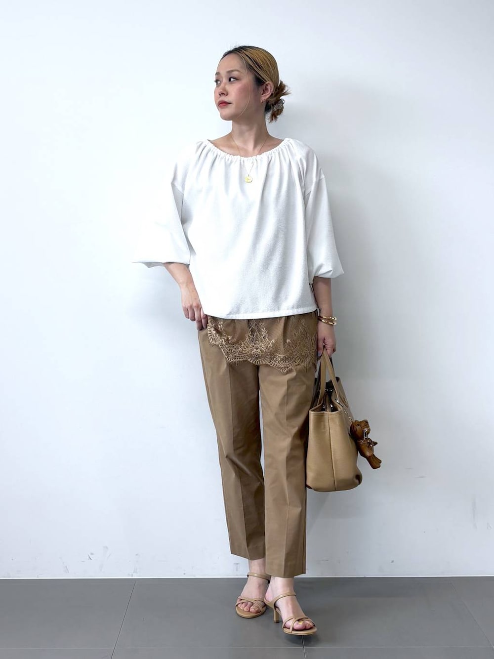 ホワイト系のシャツ/ブラウス、ベージュ系のその他パンツ、イエロー系のトートバッグを着用したレディースの春コーディネートの1枚目の写真