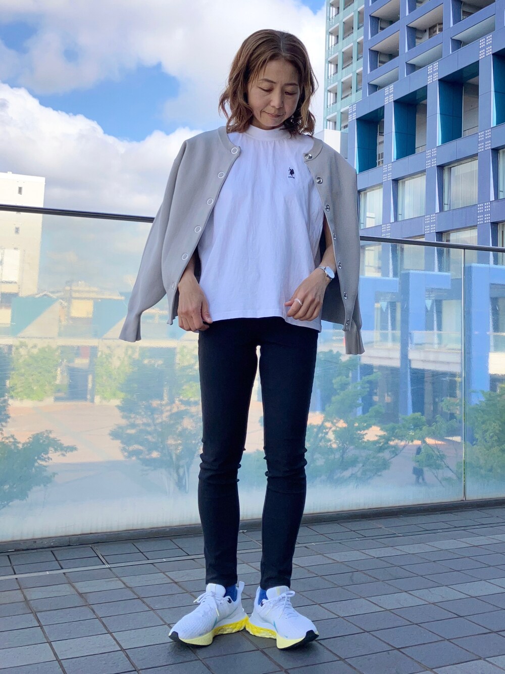 ホワイト系のTシャツ/カットソー、グレー系のカーディガン/ボレロ、ブラック系のパンツを着用したレディースの春コーディネートの1枚目の写真