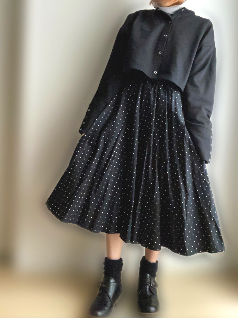 ブラック系のカーディガン/ボレロ、ブラック系のスカートを着用したレディースの春コーディネートの1枚目の写真