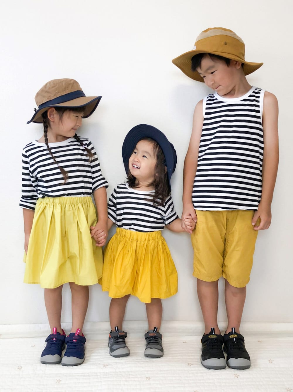 ブラック系のTシャツ/カットソー、イエロー系のスカート、イエロー系のその他パンツを着用したキッズの秋コーディネートの1枚目の写真