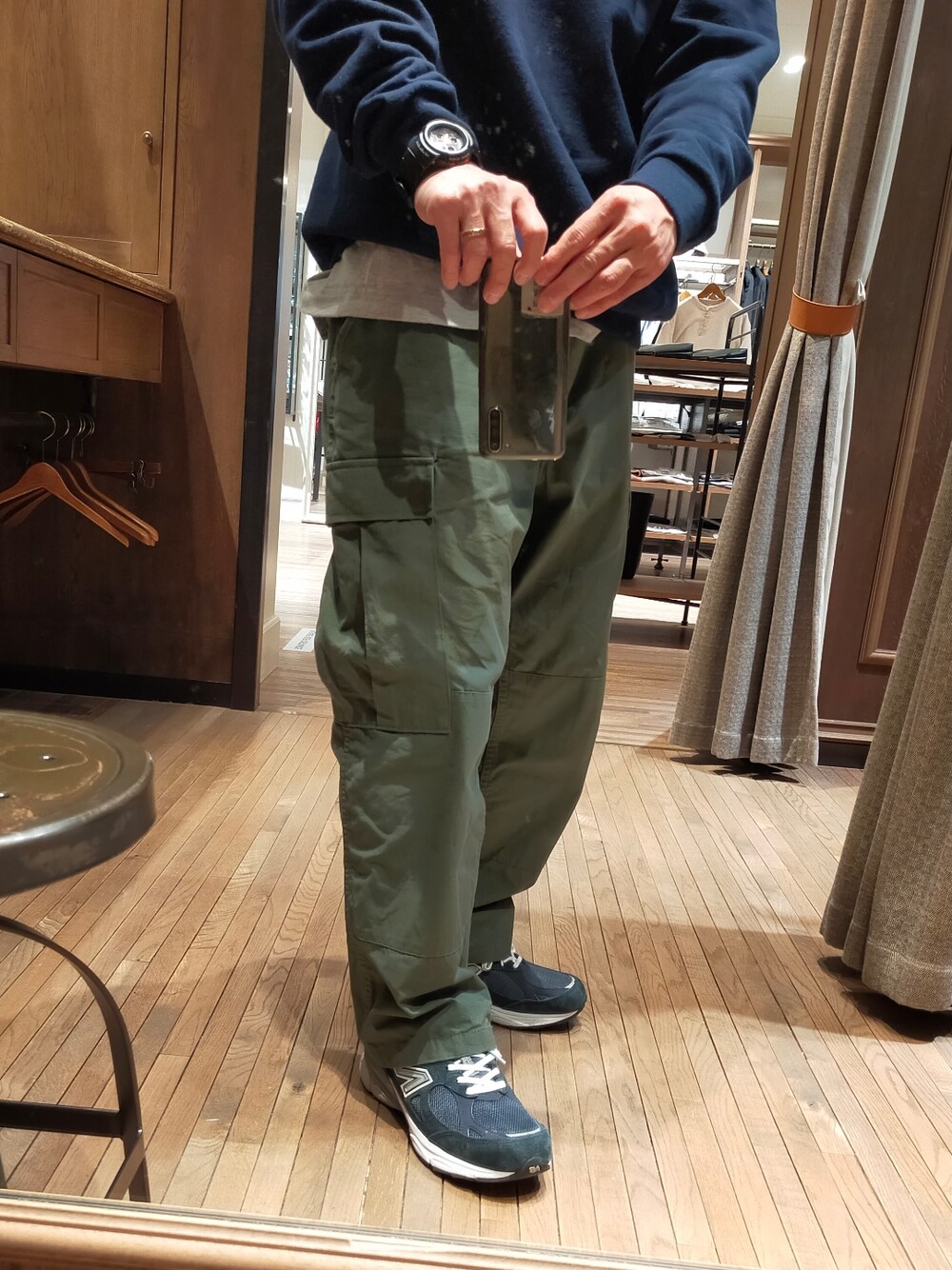 ブルー系のスウェット、グリーン系のカーゴパンツ、ブルー系のスニーカーを着用したメンズの冬コーディネートの2枚目の写真