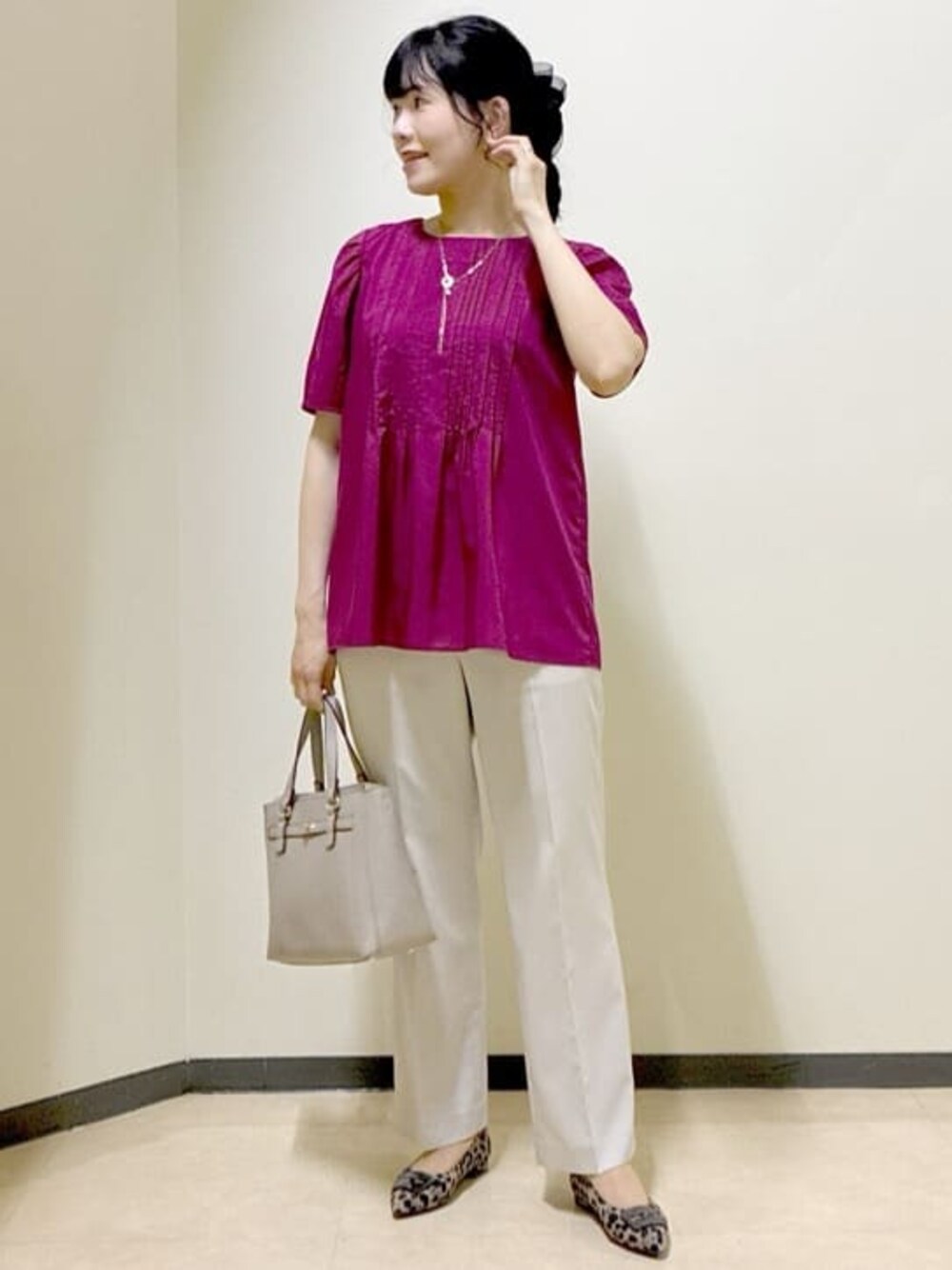 ピンク系のシャツ/ブラウス、ベージュ系のその他パンツ、ベージュ系のハンドバッグを着用したレディースの秋コーディネートの1枚目の写真