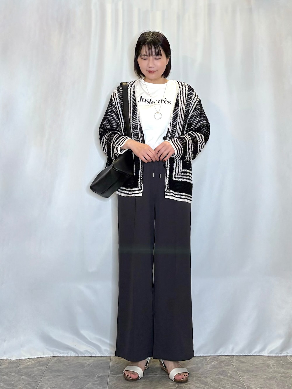 ブラック系のカーディガン/ボレロ、ホワイト系のTシャツ/カットソー、グレー系のその他パンツを着用したレディースの春コーディネートの1枚目の写真