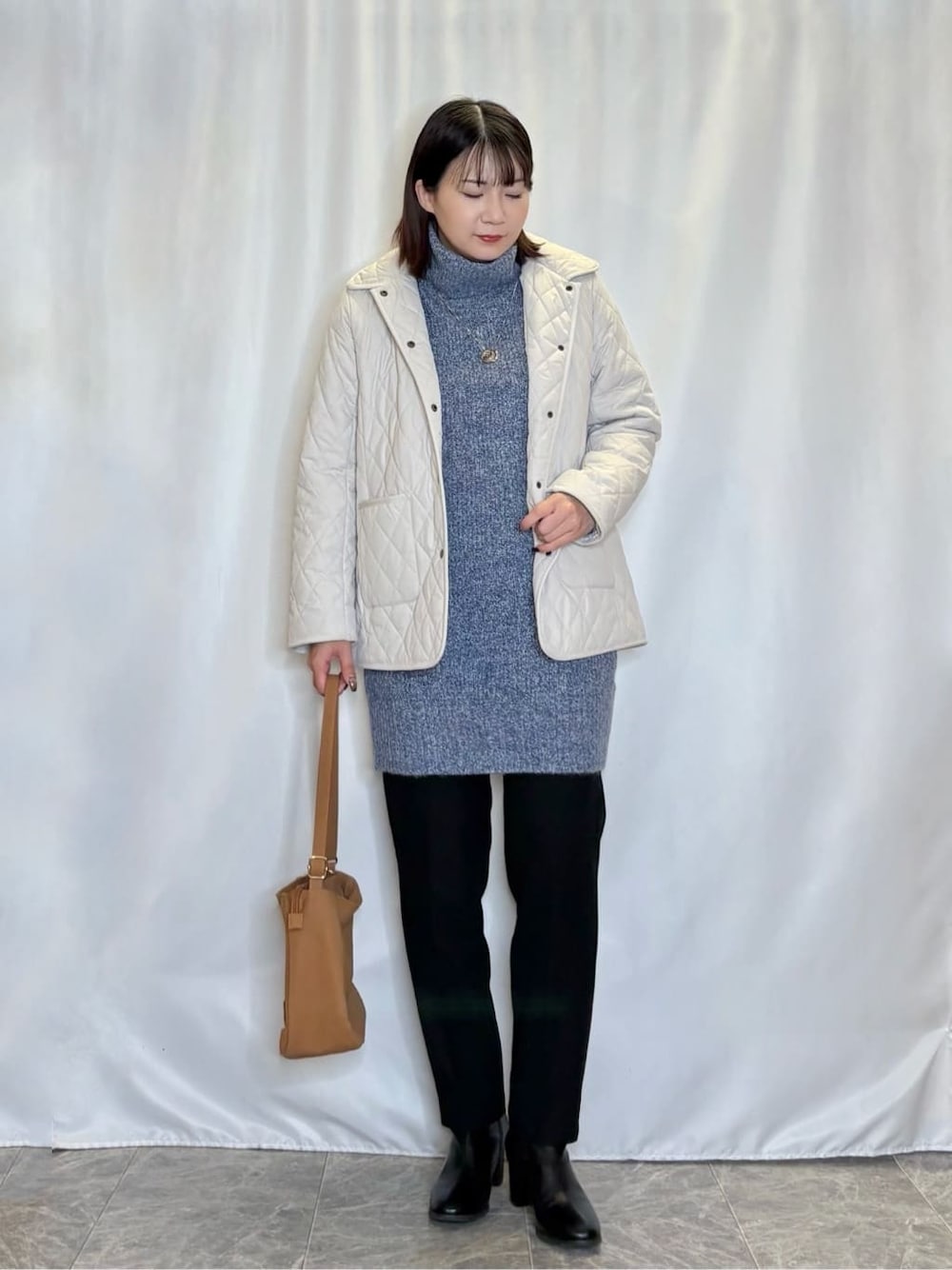 ベージュ系のその他アウター、ブルー系のニット/セーター、ブラック系のその他パンツを着用したレディースの冬コーディネートの1枚目の写真