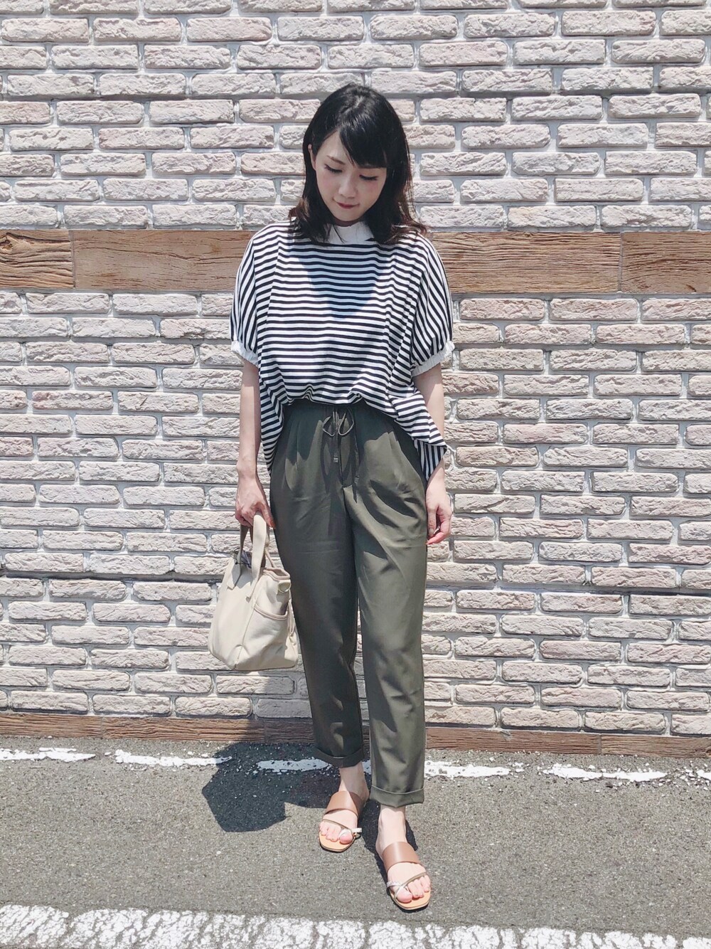 グリーン系のその他パンツ、ブラウン系のサンダル、ベージュ系のトートバッグを着用したレディースの夏コーディネートの1枚目の写真