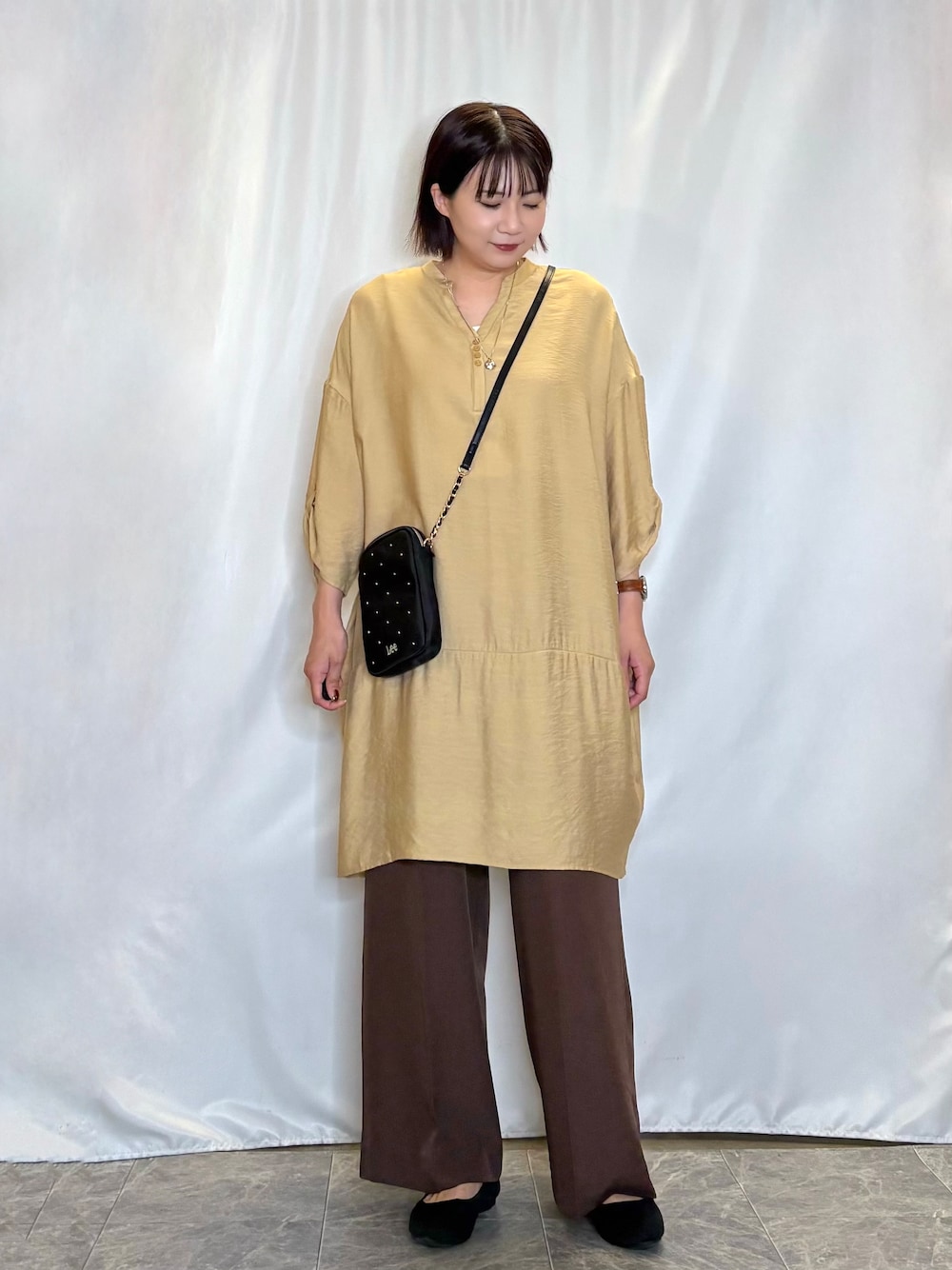 イエロー系のワンピース、ホワイト系のタンクトップ、ブラウン系のその他パンツを着用したレディースの夏コーディネートの1枚目の写真