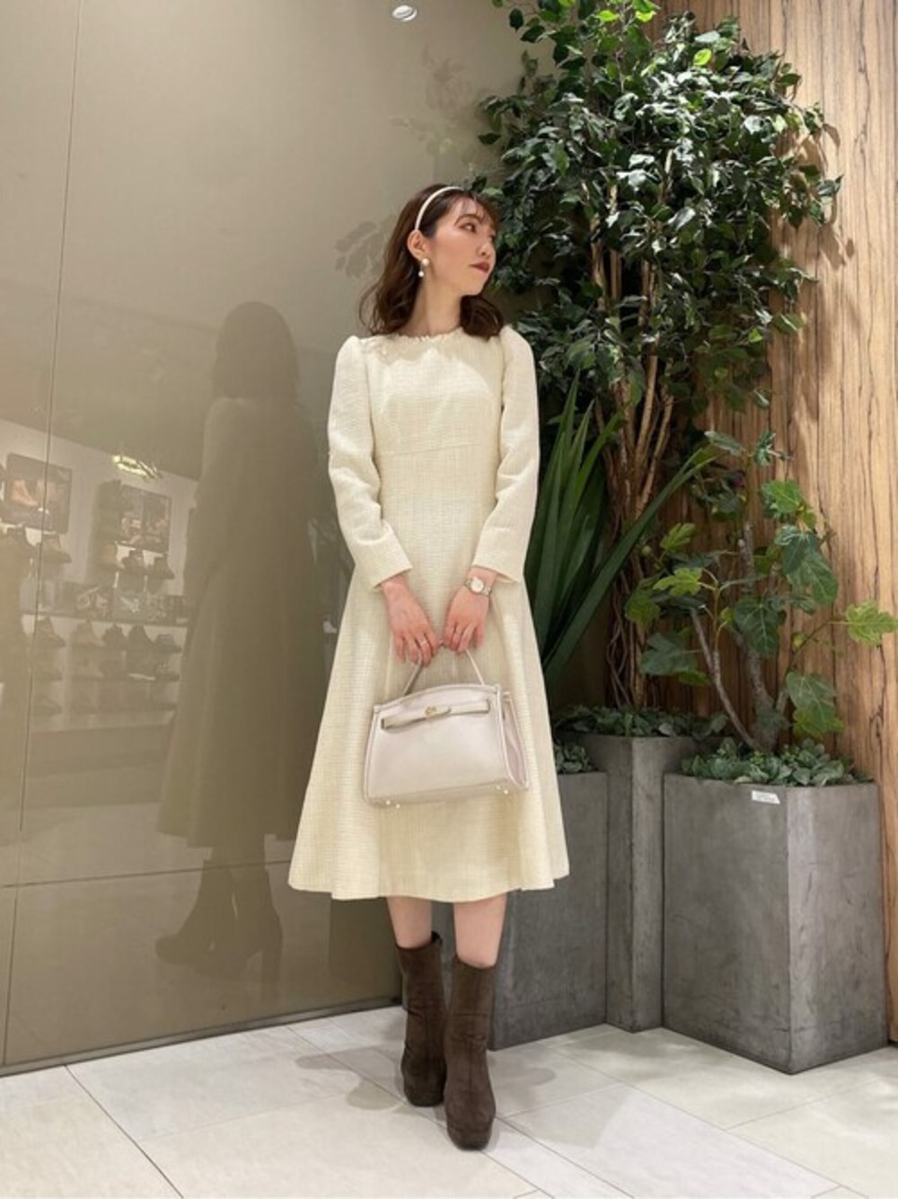 ホワイト系のワンピース、シルバー系のショルダーバッグ、ブラウン系のパンプスを着用したレディースの秋コーディネートの1枚目の写真