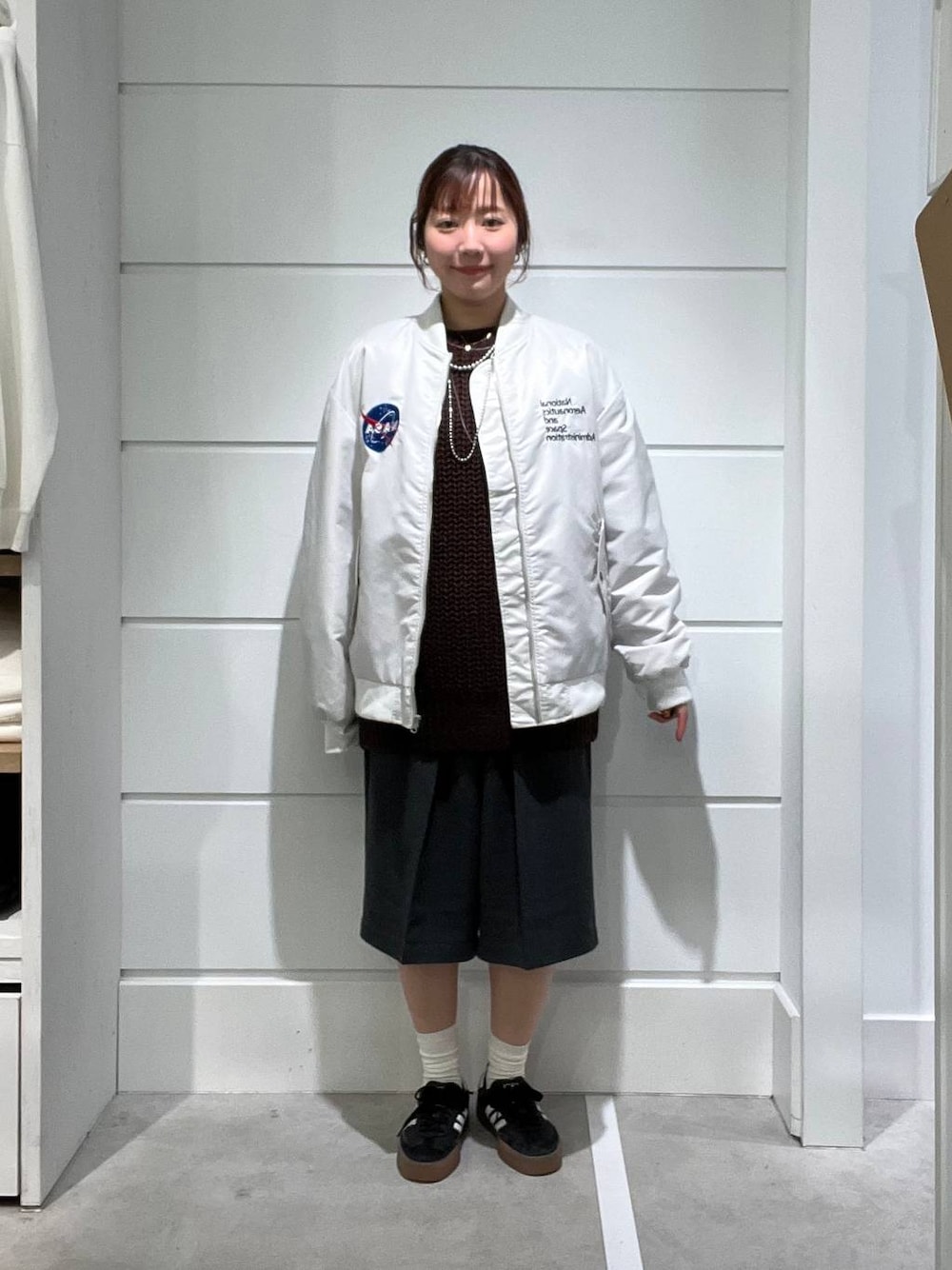 グレー系のその他パンツ、ブラウン系のニット/セーター、グレー系のブルゾンを着用したレディースの秋コーディネートの1枚目の写真