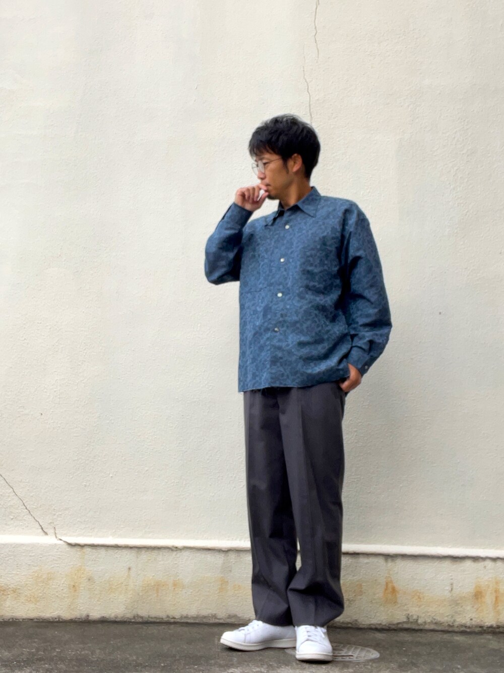 ブルー系のシャツ/ブラウス、グレー系のスラックス、ホワイト系のスニーカーを着用したメンズの秋コーディネートの1枚目の写真