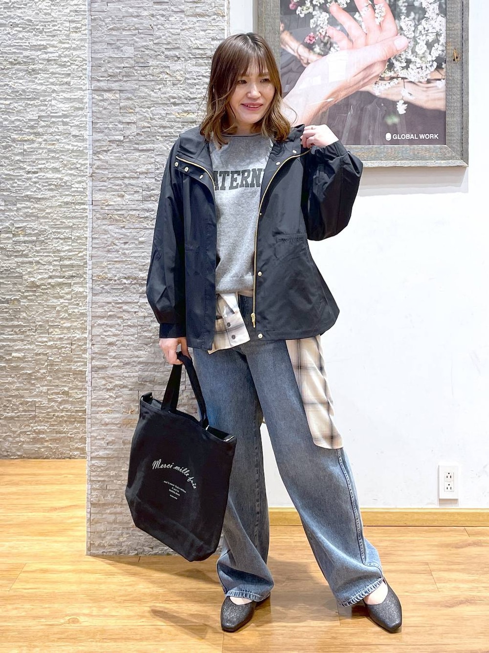 ブルー系のデニムパンツ、ブラック系のパンプス、ブルー系のマウンテンパーカーを着用したレディースの春コーディネートの1枚目の写真