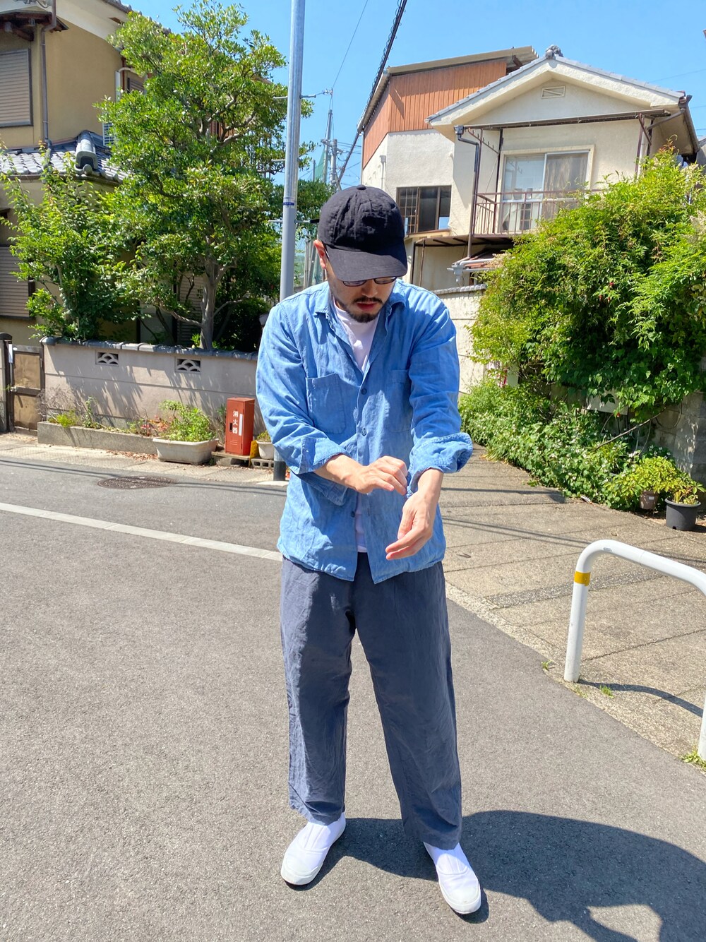 ブルー系のシャツ/ブラウス、グレー系のその他パンツ、ホワイト系のスリッポンを着用したメンズの秋コーディネートの1枚目の写真