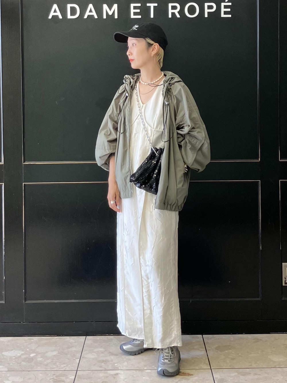 ブラック系のハンドバッグ、グリーン系のその他アウター、ホワイト系のつなぎ/オールインワンを着用したレディースの夏コーディネートの1枚目の写真