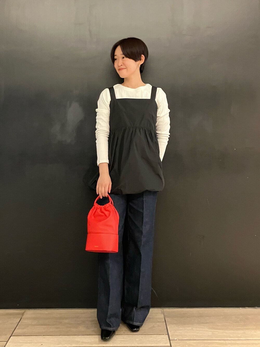 ブラック系のシャツ/ブラウス、ホワイト系のTシャツ/カットソー、ブルー系のデニムパンツを着用したレディースの冬コーディネートの1枚目の写真