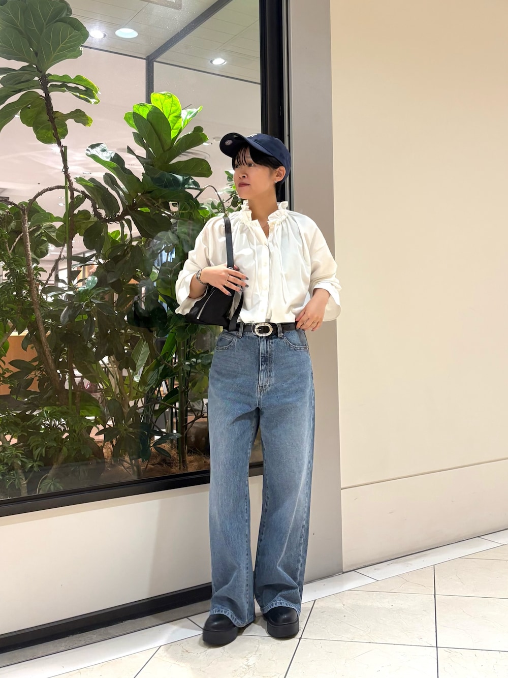 ホワイト系のシャツ/ブラウス、ブルー系のデニムパンツ、ブラック系のショルダーバッグを着用したレディースの秋コーディネートの1枚目の写真