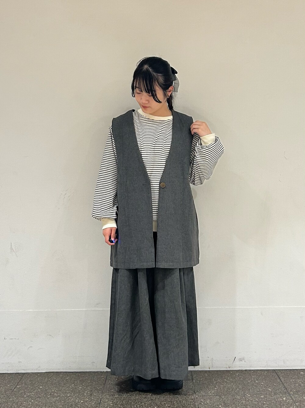 ブラック系のブーツ、ブラック系のベスト、ブラック系のその他パンツを着用したレディースの秋コーディネートの1枚目の写真