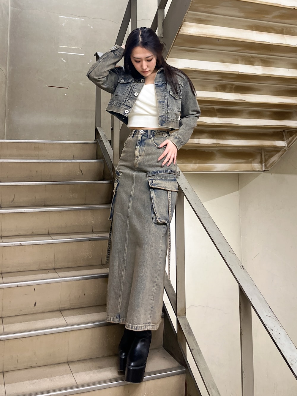 ブルー系のデニムジャケット、ブルー系のデニムスカート、ホワイト系のTシャツ/カットソーを着用したレディースの冬コーディネートの1枚目の写真