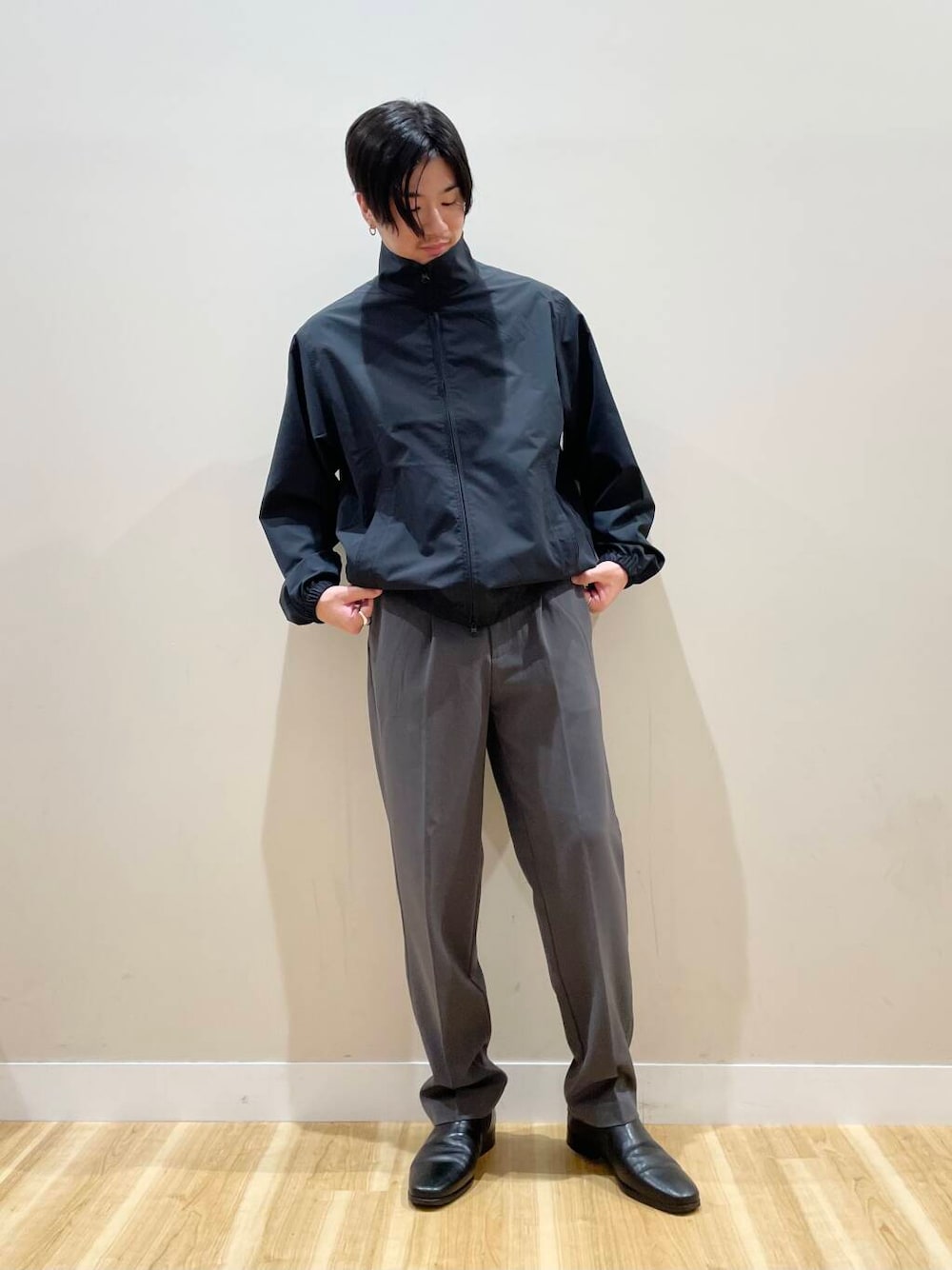 グレー系のその他パンツ、ブラック系のブルゾンを着用したメンズの秋コーディネートの1枚目の写真