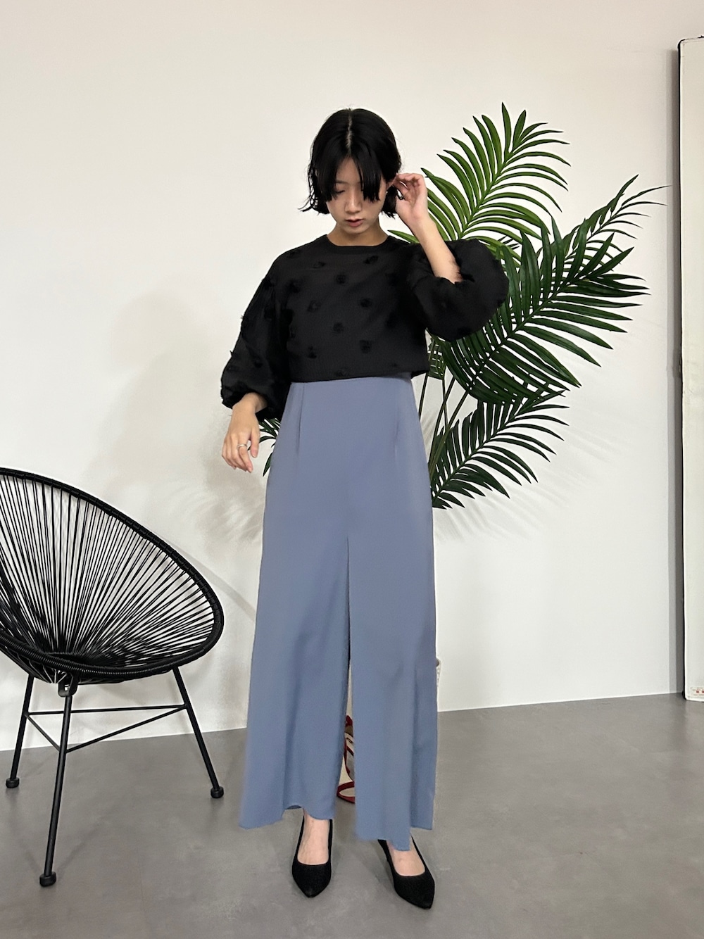 ブラック系のパンツドレスを着用したレディースの秋コーディネートの1枚目の写真