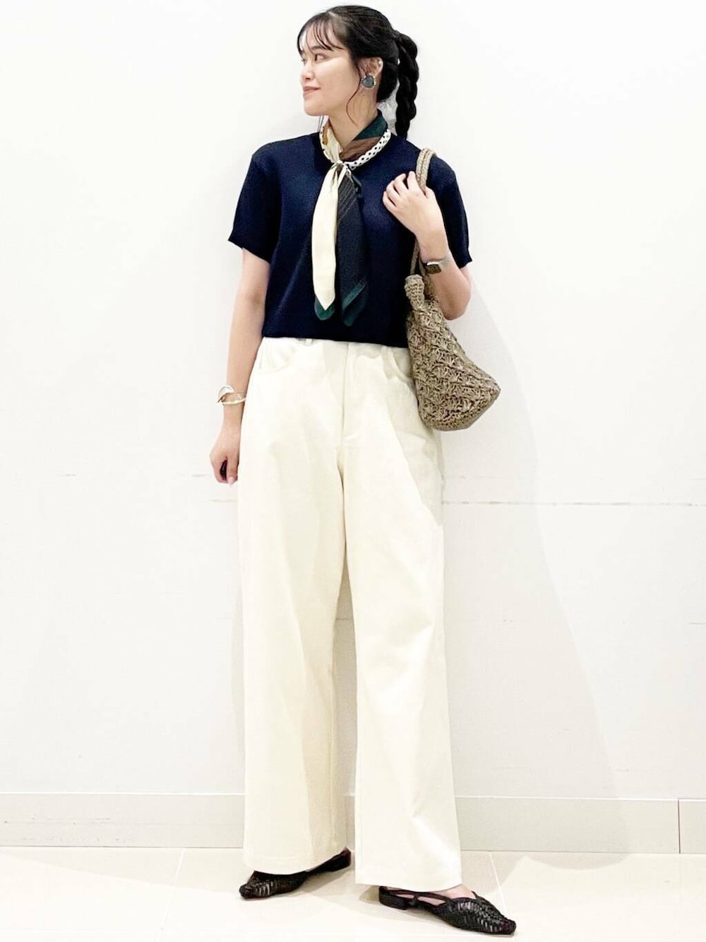 グレー系のトートバッグ、ブラック系のサンダル、ブルー系のニット/セーターを着用したレディースの夏コーディネートの1枚目の写真