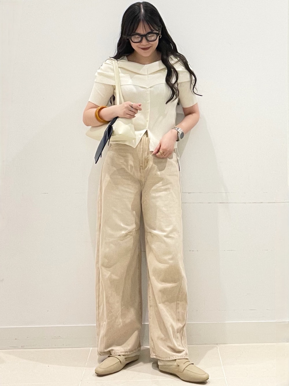 ベージュ系のローファー、ベージュ系のデニムパンツ、ホワイト系のニット/セーターを着用したレディースの春コーディネートの1枚目の写真