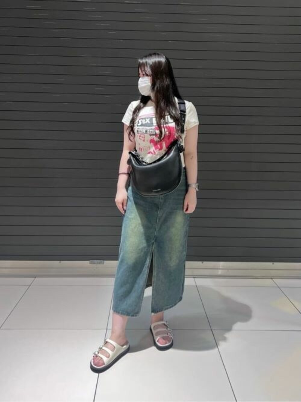 ブラック系のショルダーバッグ、ホワイト系のサンダルを着用したレディースの夏コーディネートの1枚目の写真