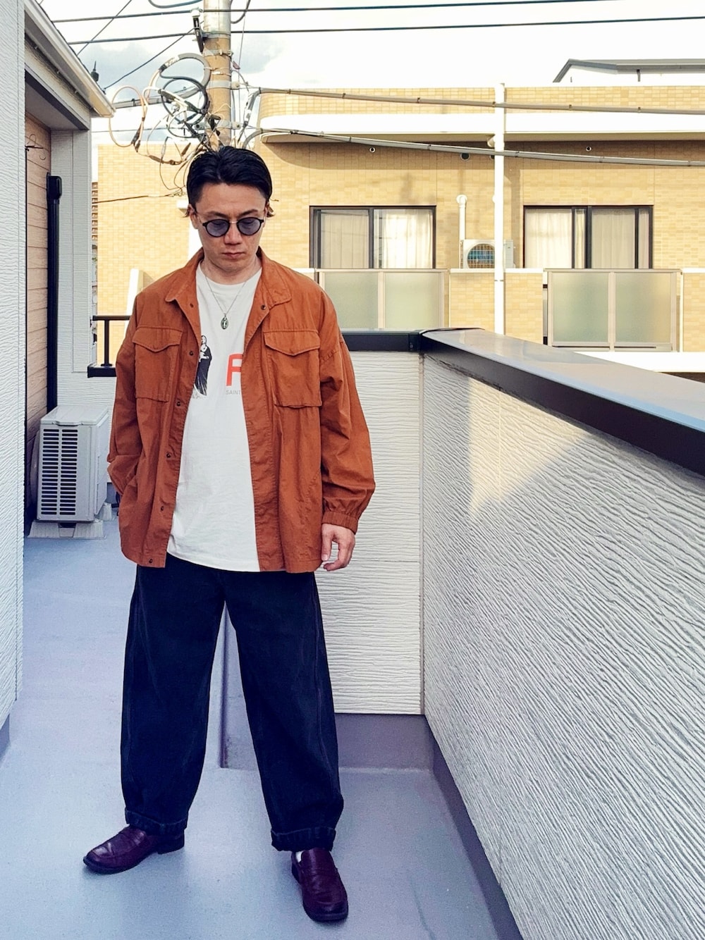 ブラック系のデニムパンツ、ホワイト系のTシャツ/カットソー、ブラウン系のシャツ/ブラウスを着用したメンズの春コーディネートの1枚目の写真