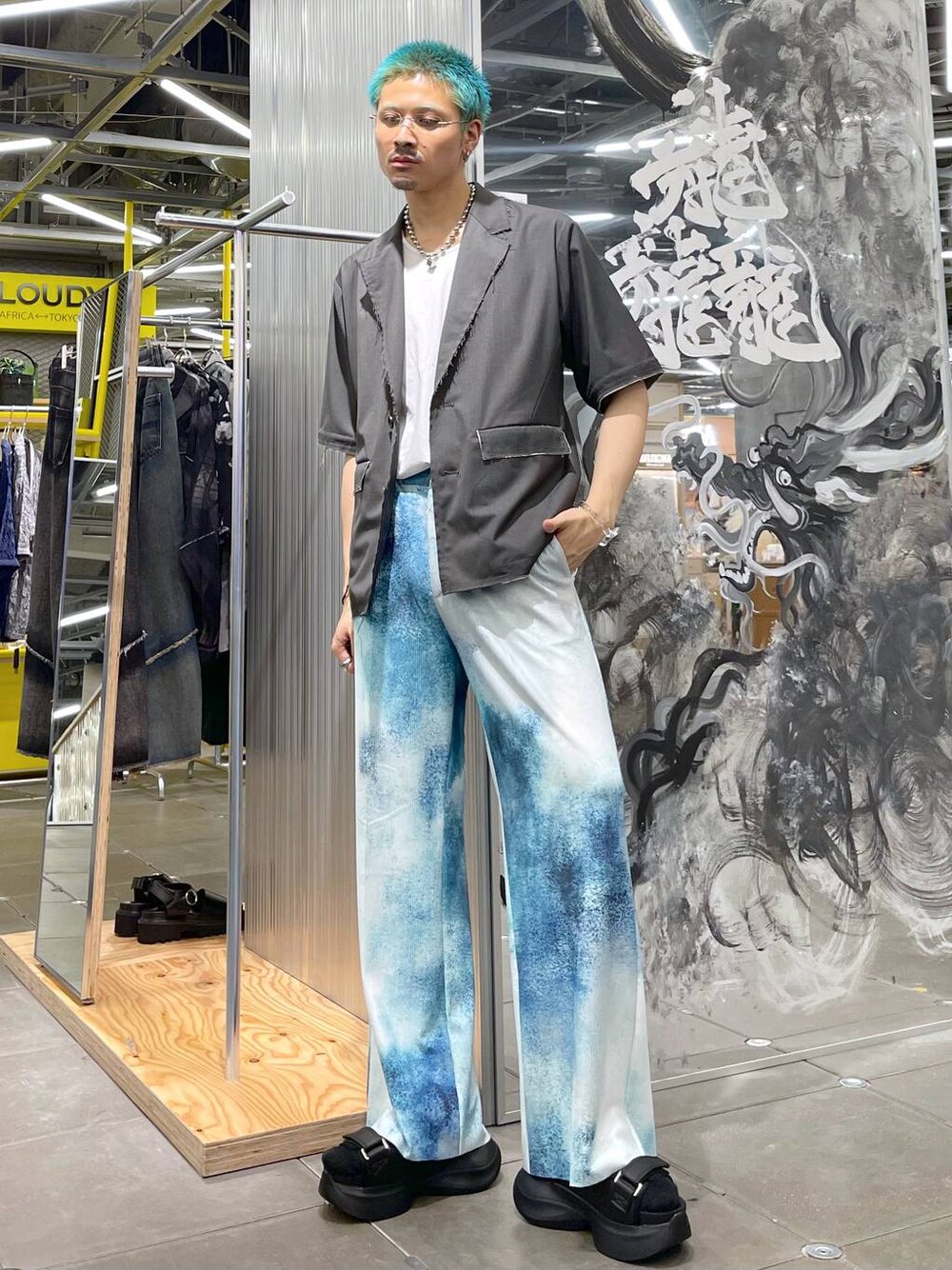 ブラック系のサンダル、グレー系のテーラードジャケット、ブルー系のその他パンツを着用したメンズの夏コーディネートの1枚目の写真