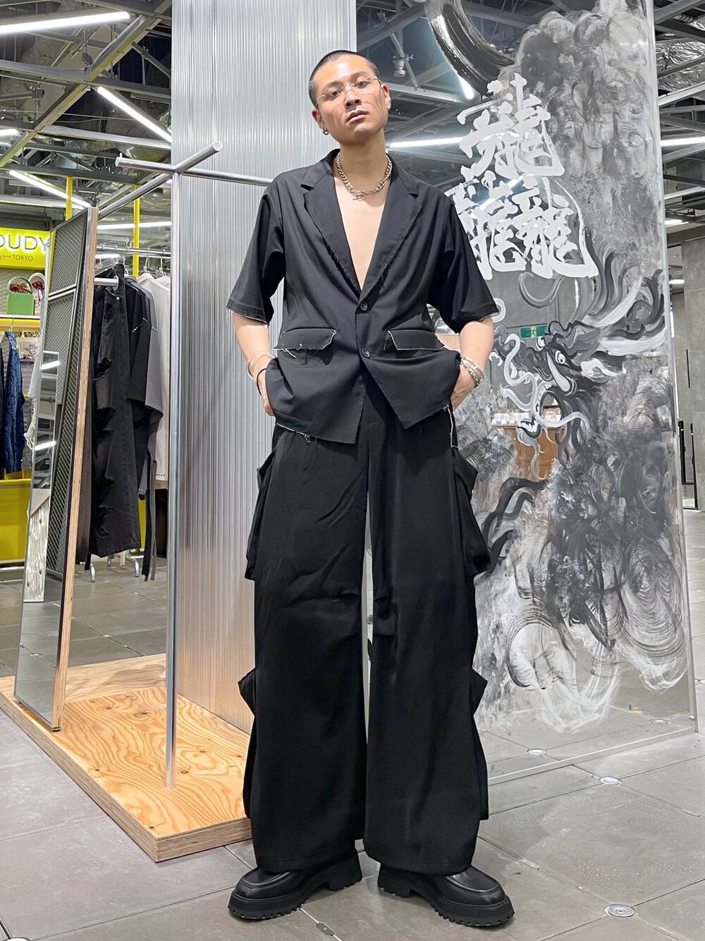 ブラック系のテーラードジャケット、ブラック系のドレスシューズ、ブラック系のカーゴパンツを着用したメンズの夏コーディネートの1枚目の写真